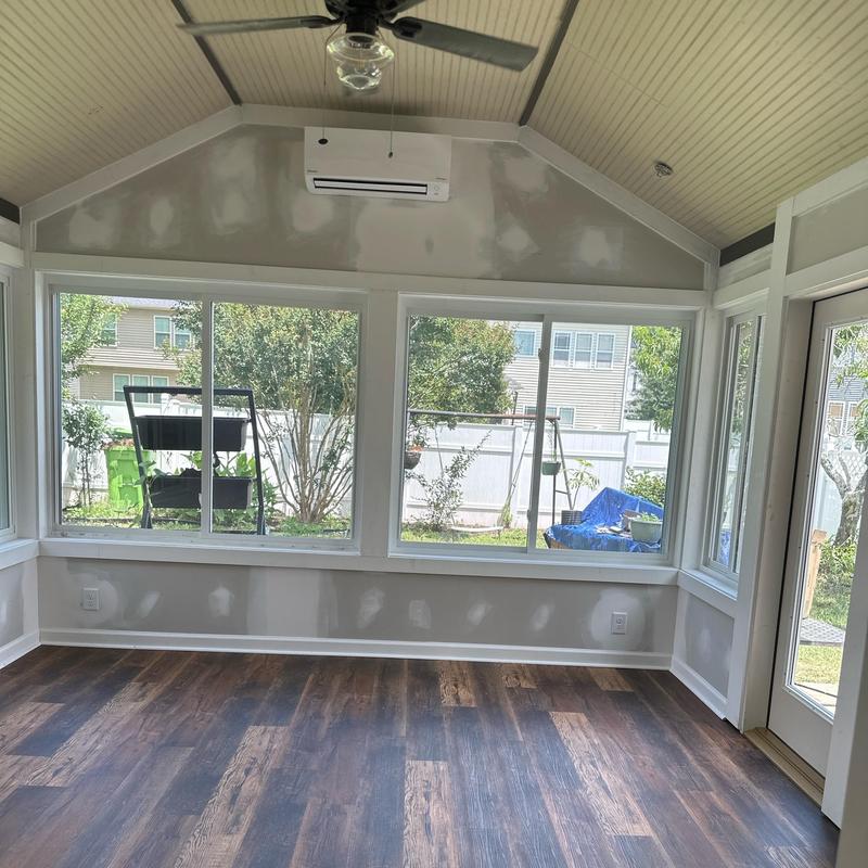 Sunroom interior with new flooring and windows Sunroom interior with new flooring and windows
