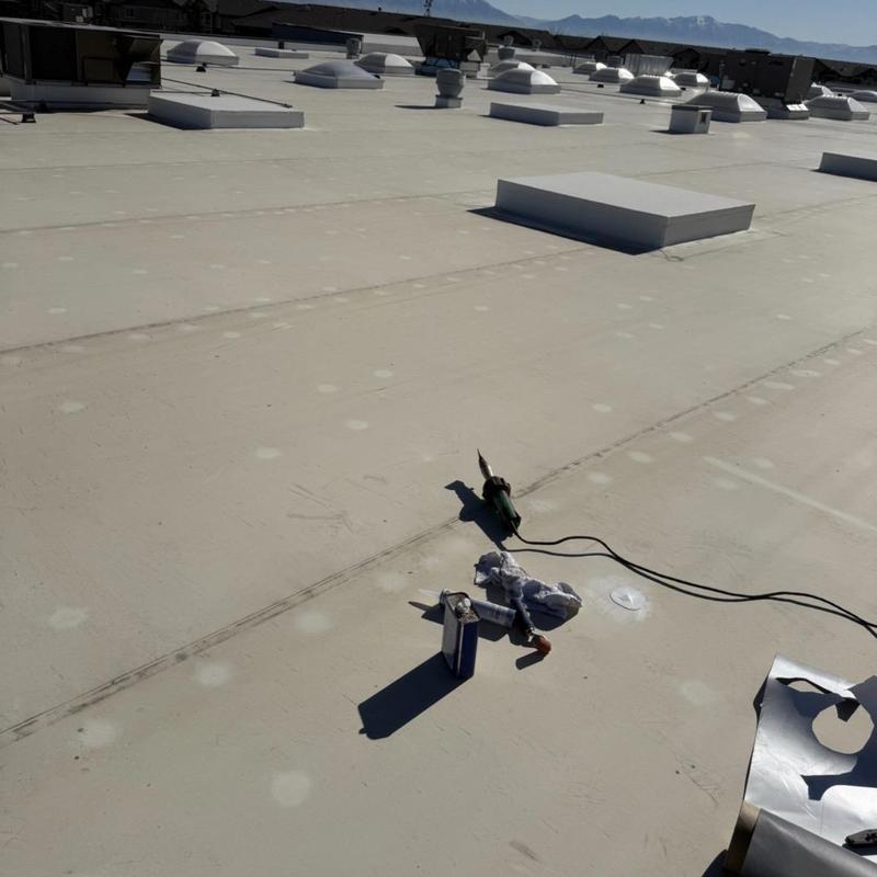 TPO roofing membrane with welding tools on commercial roof