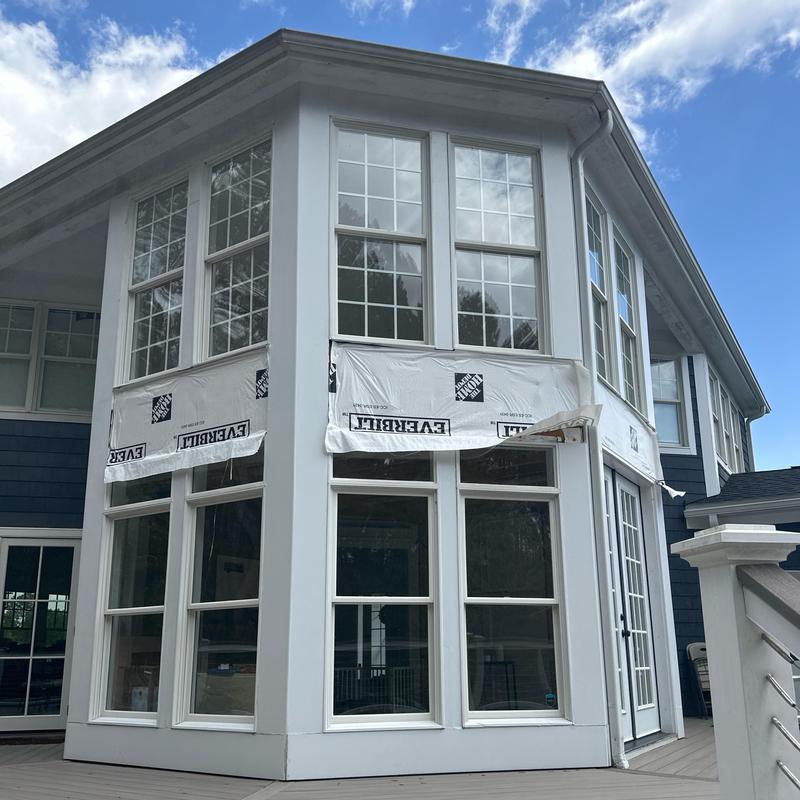 Bay window installation with white trim and siding Bay window installation with white trim and siding