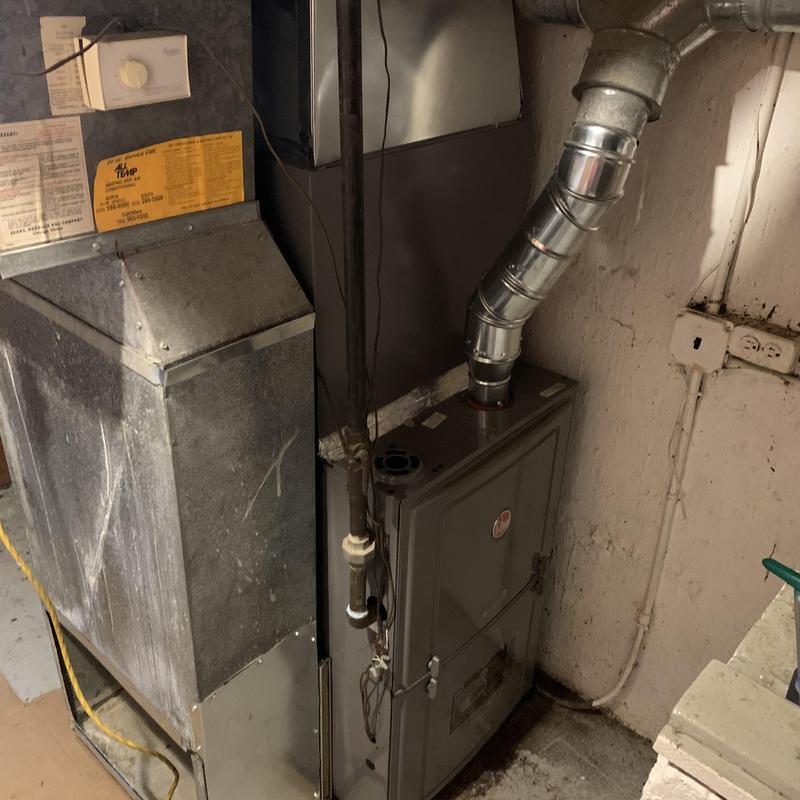 100,000 BTU gas furnace with ductwork in basement