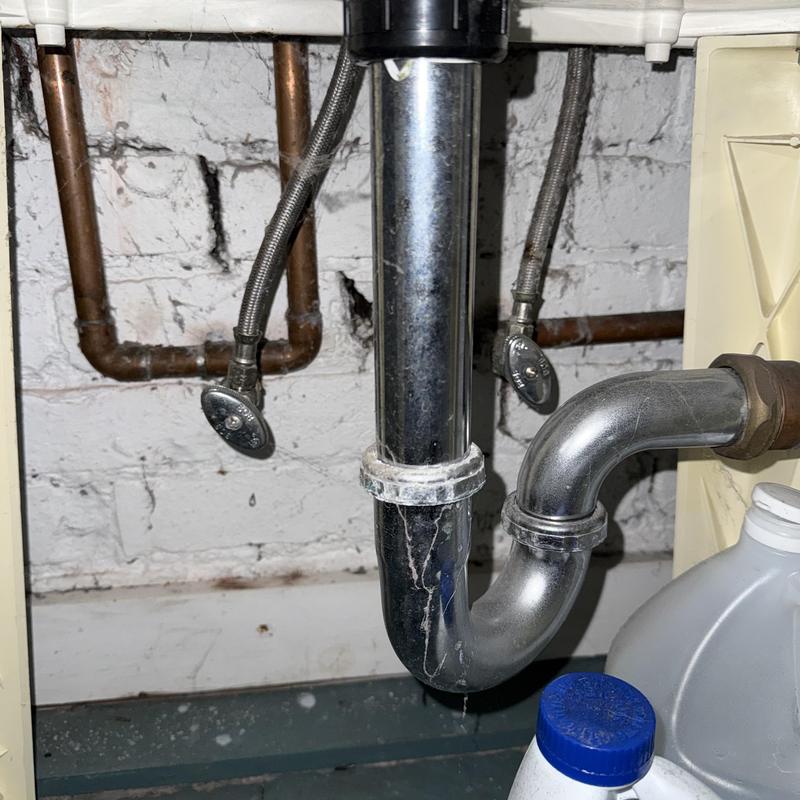 Toilet fill valve and drain pipe under sink