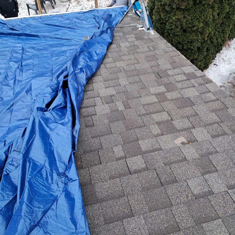 Roof shingles with blue tarp for temporary covering Roof shingles with blue tarp for temporary covering