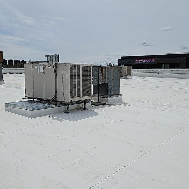 TPO flat roof with HVAC units and metal vents TPO flat roof with HVAC units and metal vents