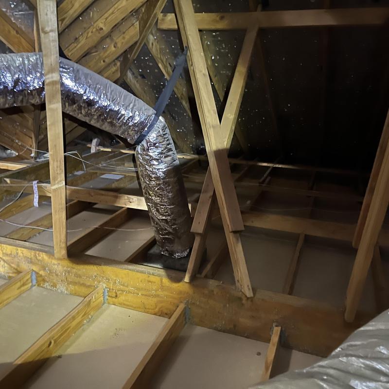 Attic insulation removal and ductwork in wooden frame attic