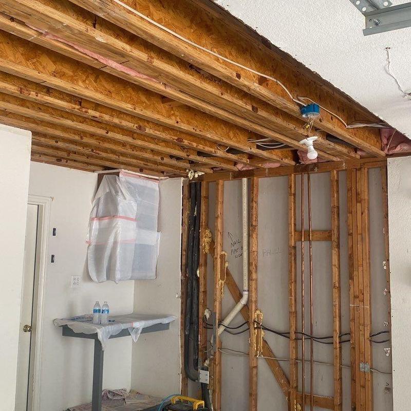 Garage ceiling and wall studs exposed during repair