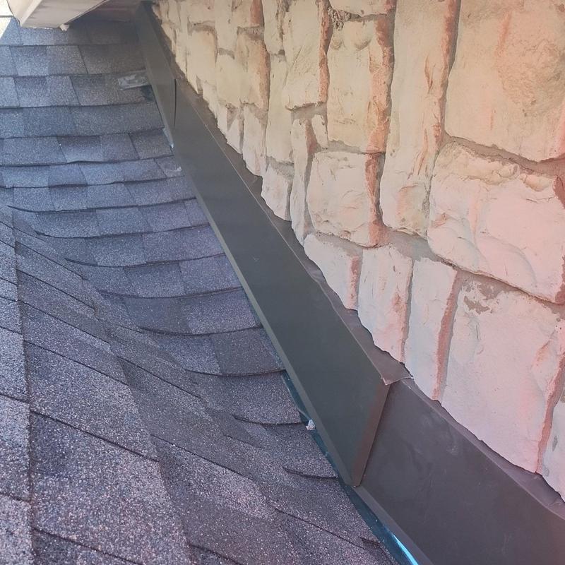 Castle turret roof flashing with stone wall integration