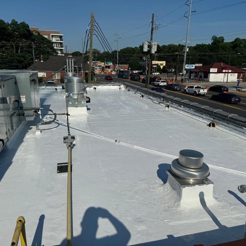 Flat roof silicone coating on commercial building