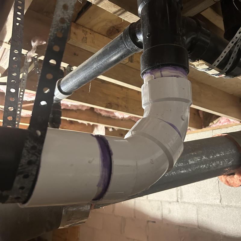 Sewage pipe section with new PVC elbow fitting