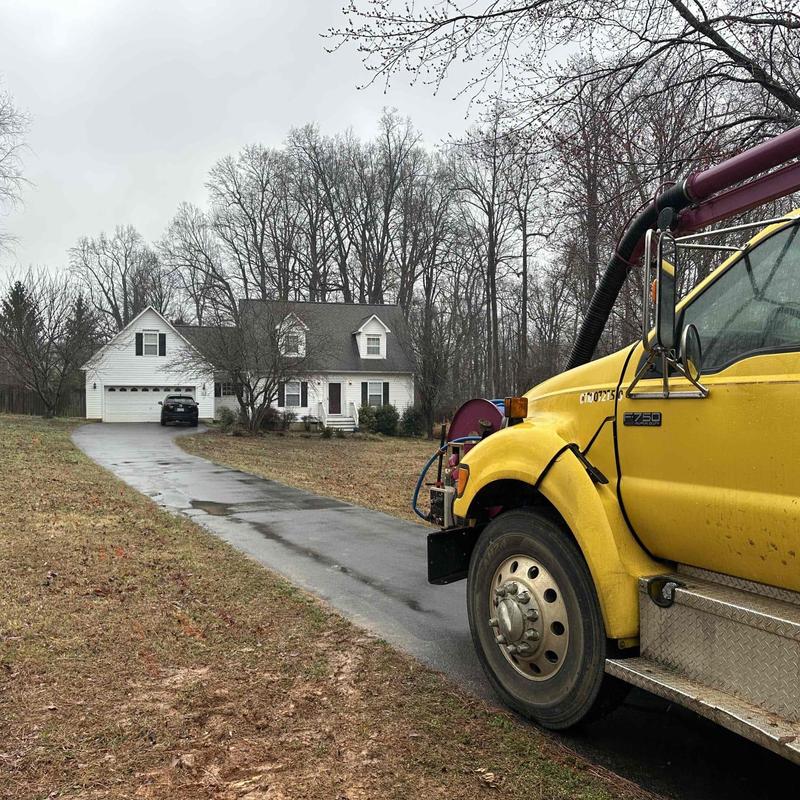 Septic tank maintenance with yellow vacuum truck Septic tank maintenance with yellow vacuum truck