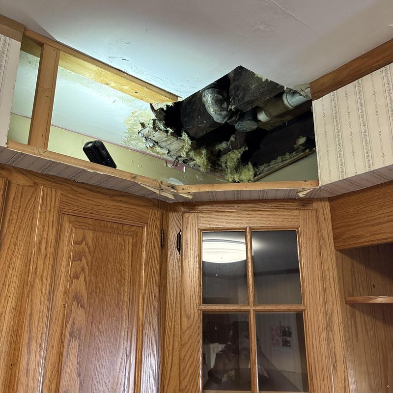 Galvanized pipe leak in ceiling above cabinet soffit