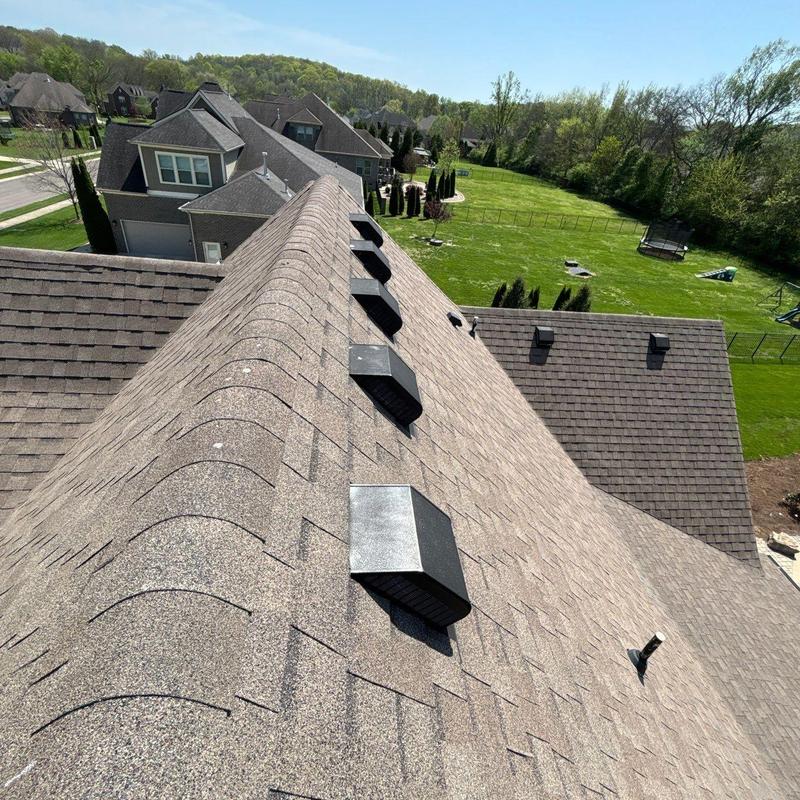 Architectural shingle roof with ridge vents and hail damage