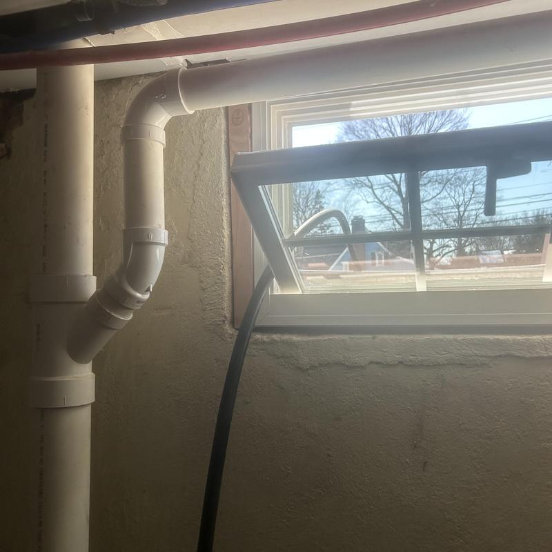 PVC drain pipe with jet cleaning hose near window PVC drain pipe with jet cleaning hose near window