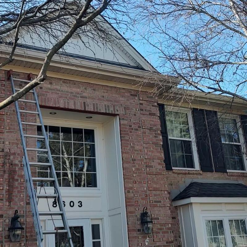 Seamless aluminum gutters with black Shur Flo guards installation