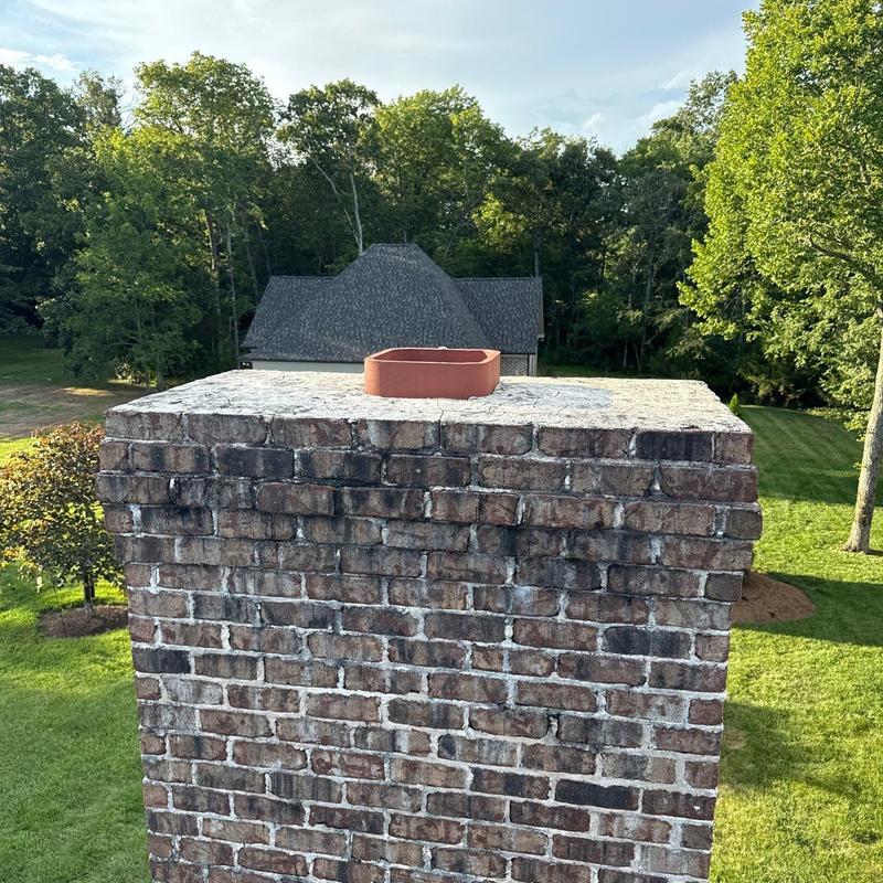 Brick chimney top with metal flue liner on roof