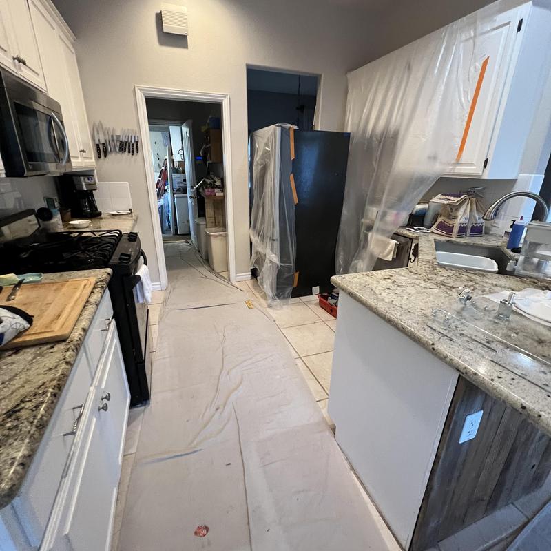 Kitchen PEX pipe repiping in progress with protective covering