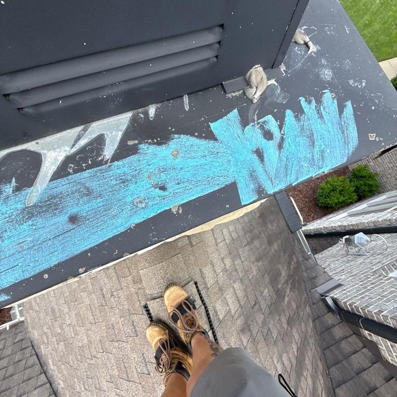 Metal flashing with sealant and chalk markings on roof edge