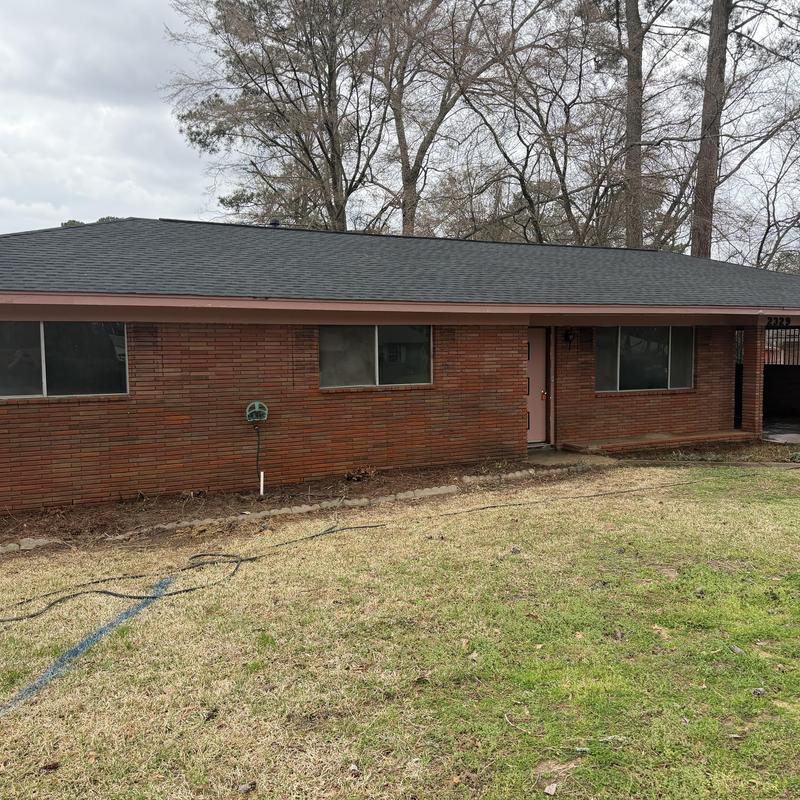 Brick exterior of house before paint preparation