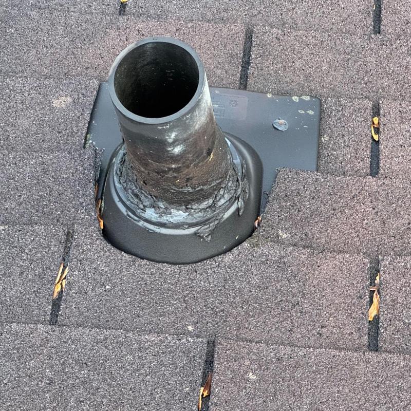 Roof vent pipe flashing on shingle roof close-up