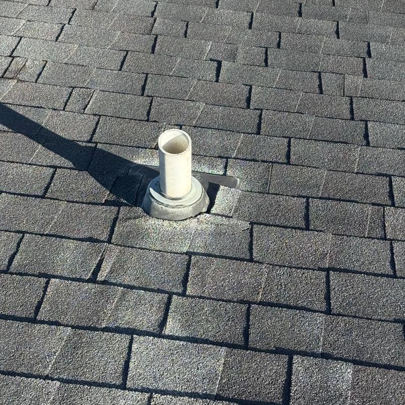 Pipe boot on asphalt shingle roof with shadow