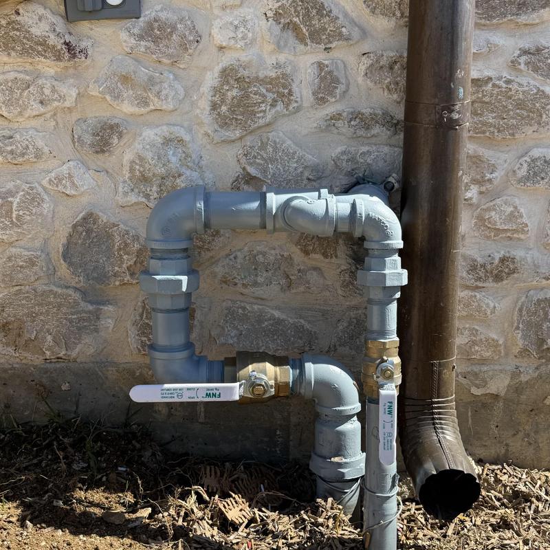 Gas connection piping with valves outside stone wall