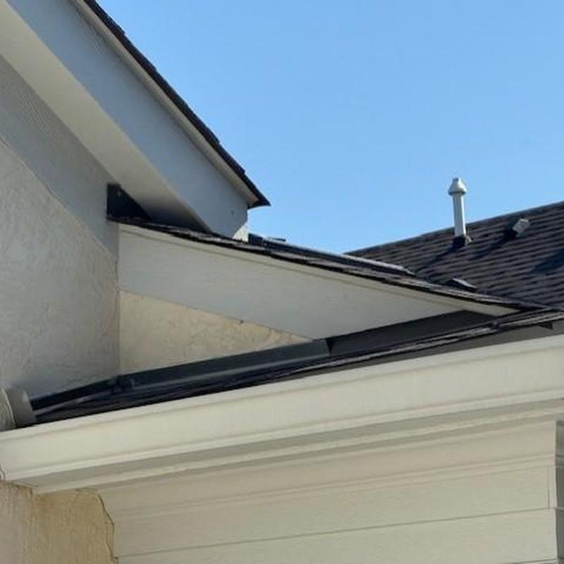 Asphalt shingle roof valley with debris buildup Asphalt shingle roof valley with debris buildup