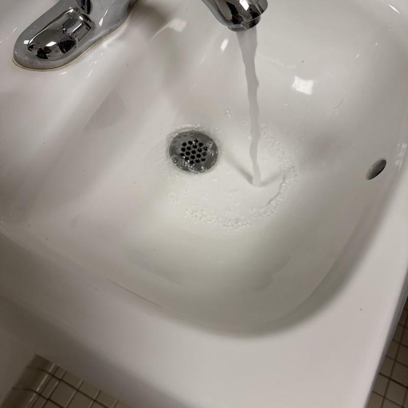 Bathroom sink and faucet with running water Bathroom sink and faucet with running water