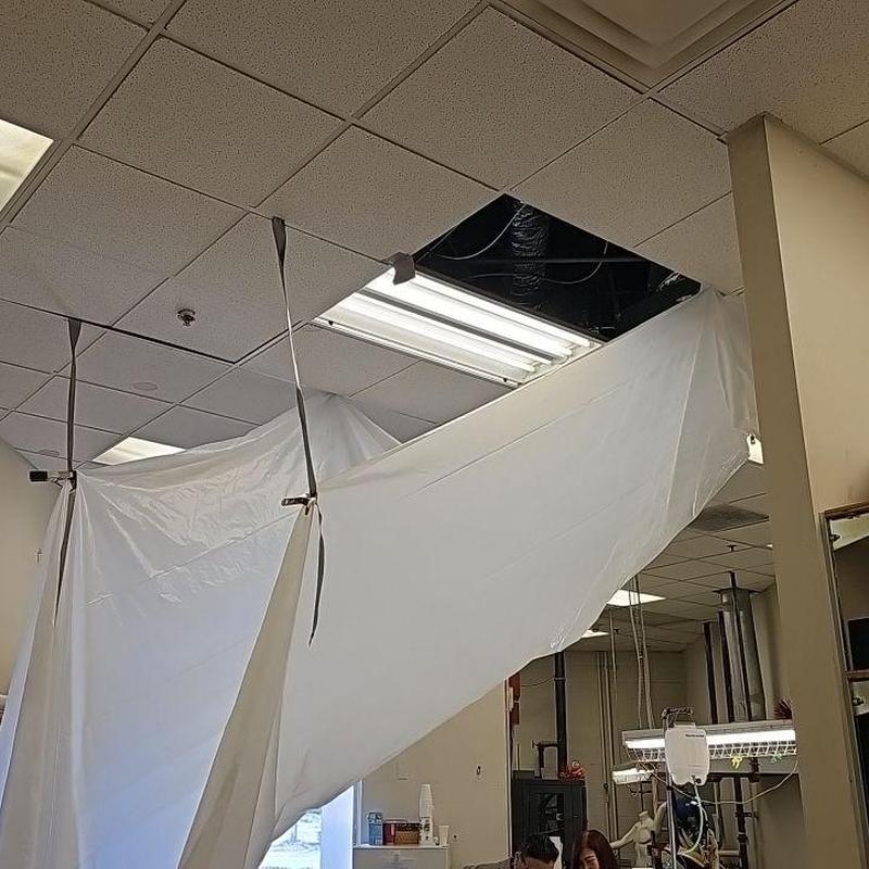 Ceiling tile containment with removed panel and tarp Ceiling tile containment with removed panel and tarp