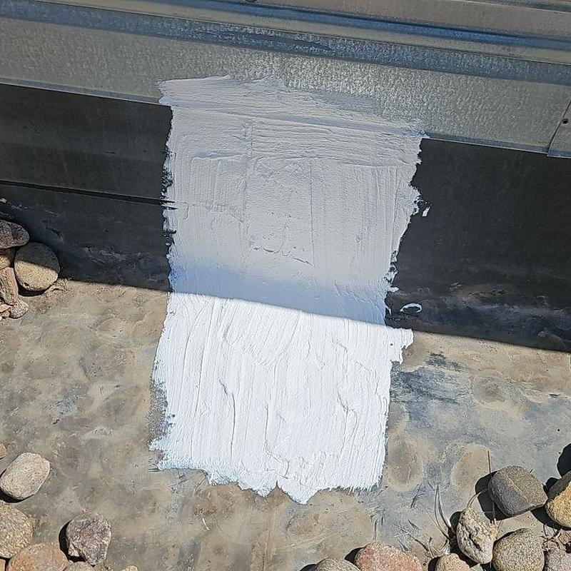 EPDM flat roof leak with white silicone patch EPDM flat roof leak with white silicone patch