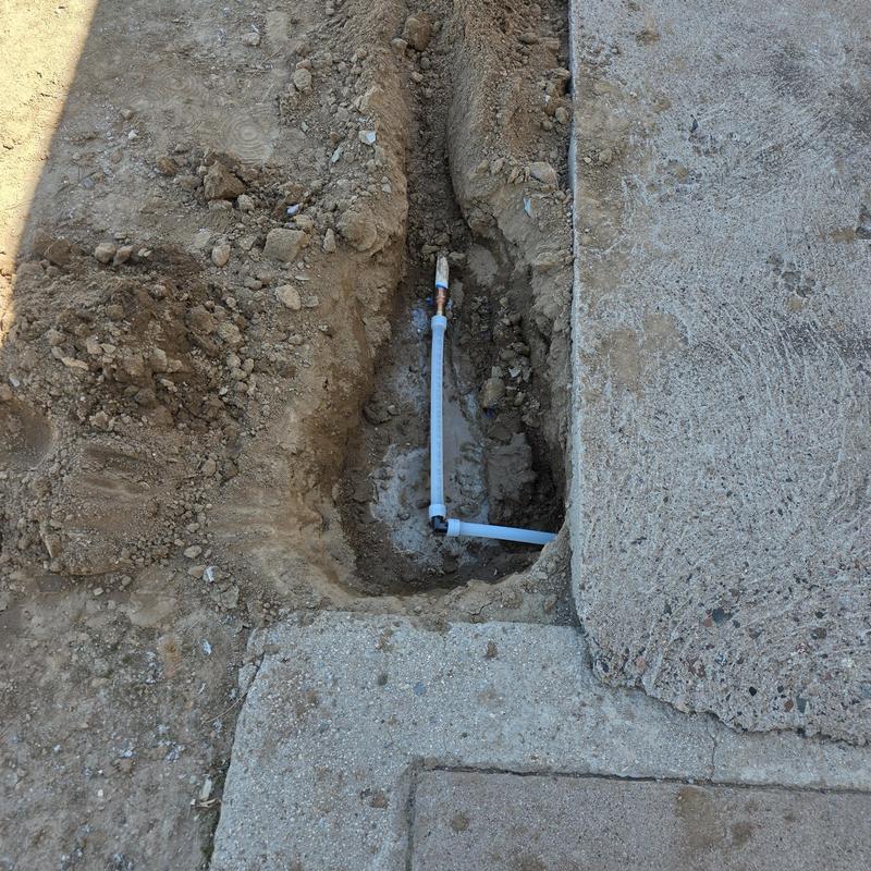 Hot water line repipe in trench next to sidewalk