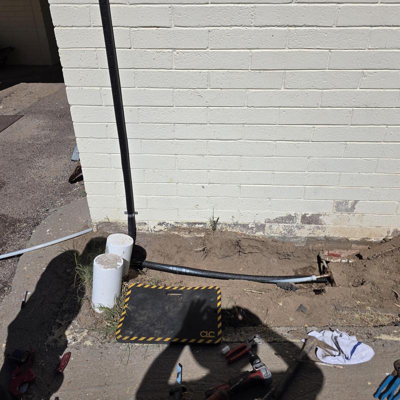 Hot water line repiping on exterior home wall