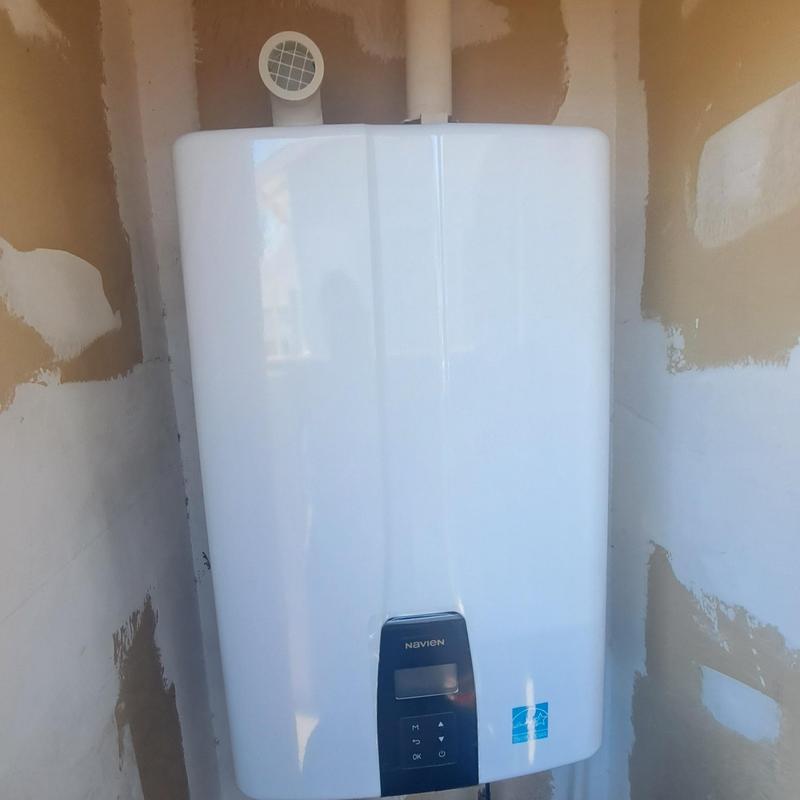 Tankless water heater in installation closet exterior