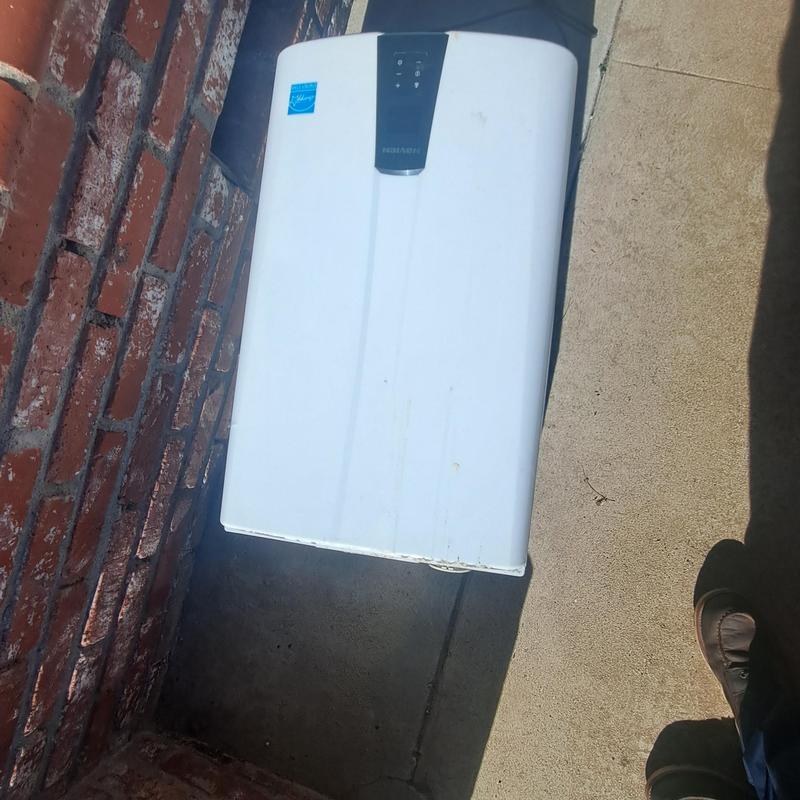 Tankless water heater unit installed outdoors