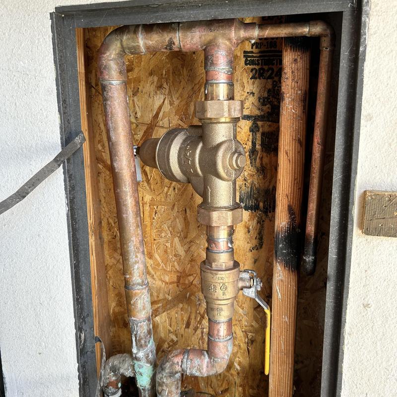Brass pressure reducing valve with copper pipes installed