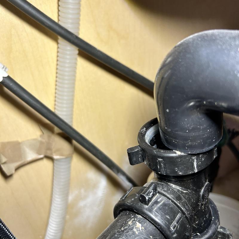 Kitchen sink drain pipe with loose connection under cabinet