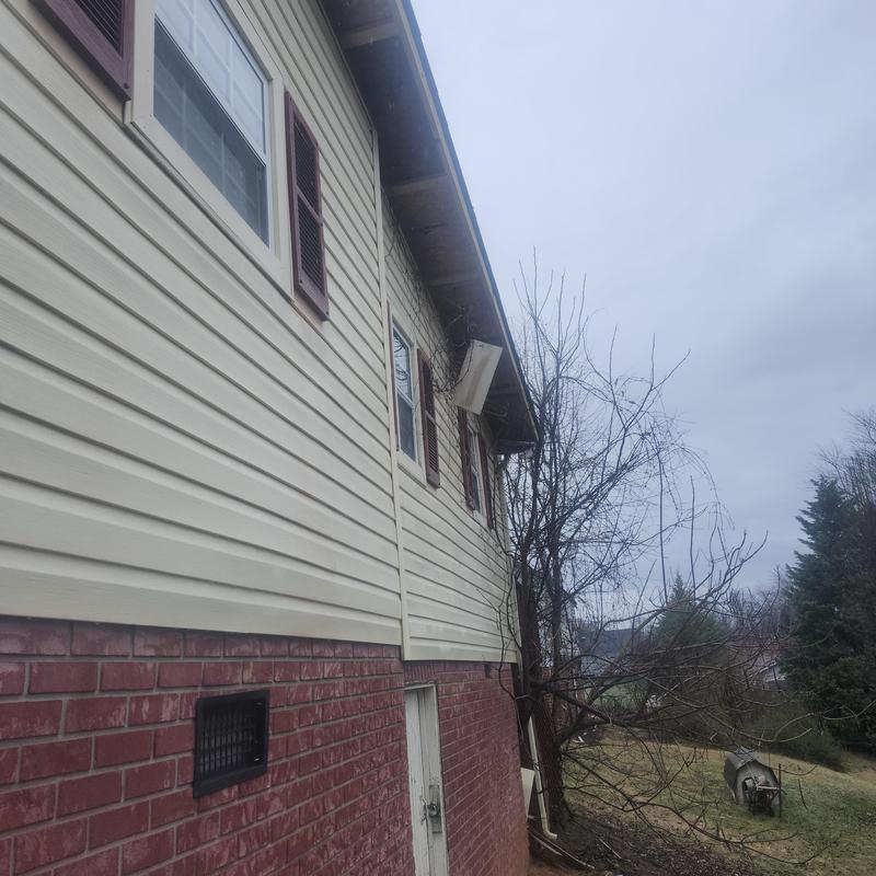 Vinyl soffit installation on residential house exterior