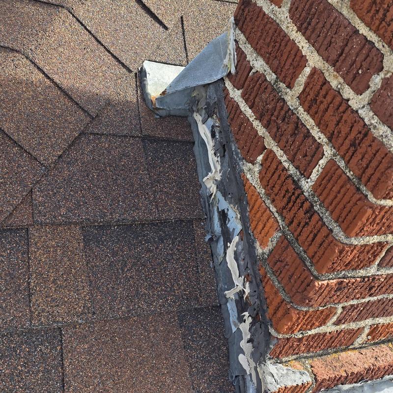 Roof chimney flashing with sealing damage and wear