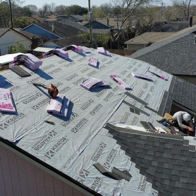 Synthetic roofing underlayment installation on residential roof