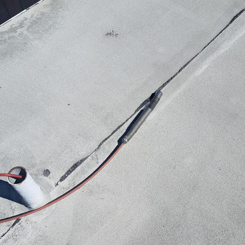 Roof vent sewer line with hydrojet hose inserted