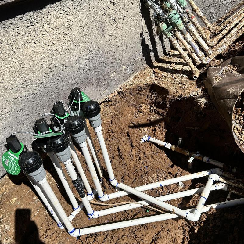 Irrigation valves and PVC piping installation in trench