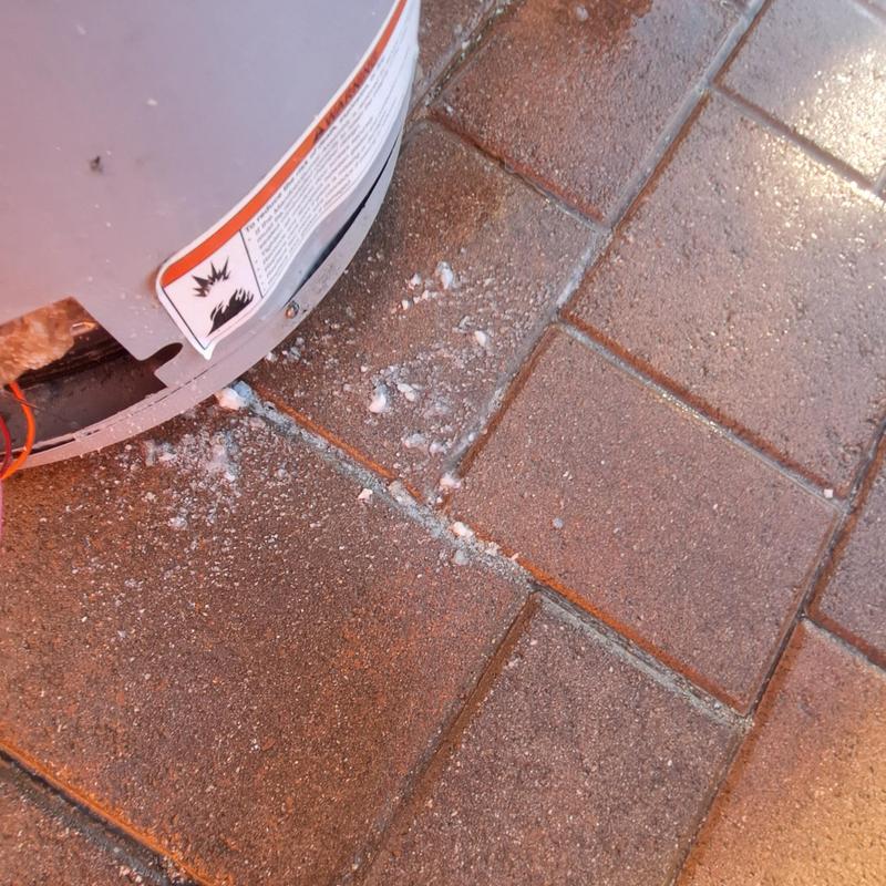 40 gallon gas water heater base and floor debris