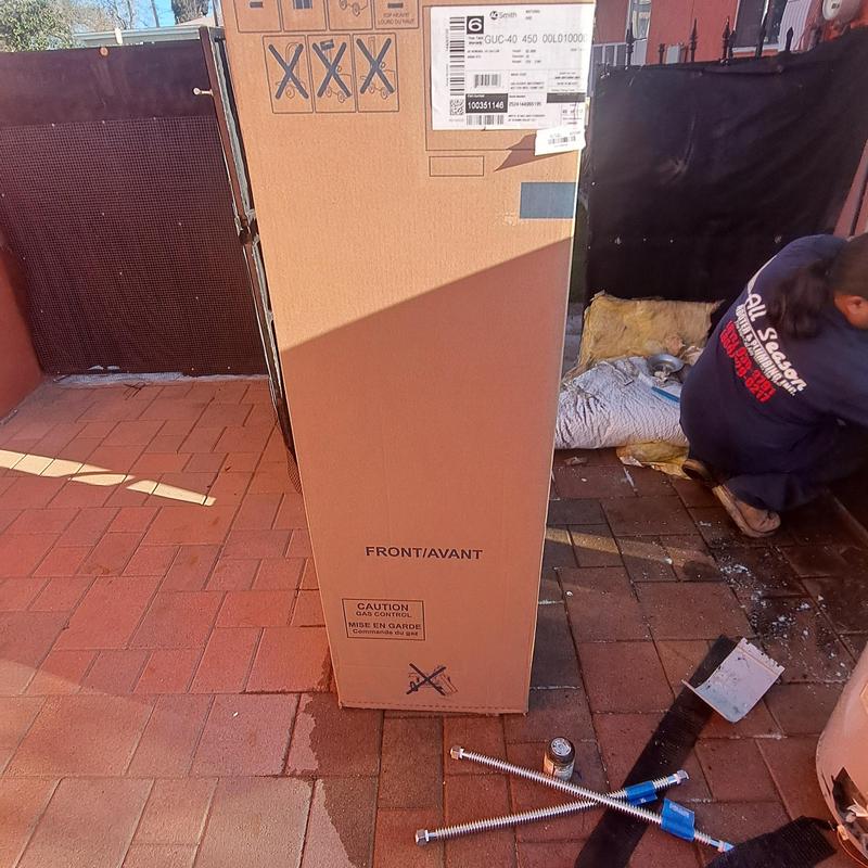 40 gallon gas water heater in packaging outdoors