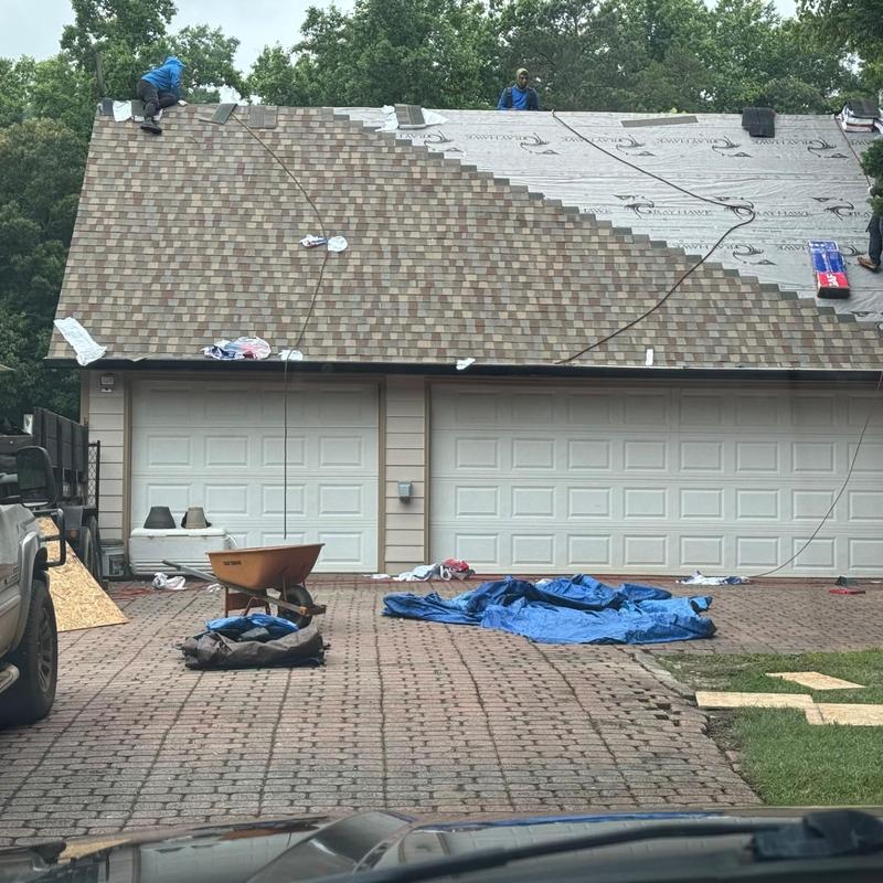 Asphalt shingle roof installation in progress
