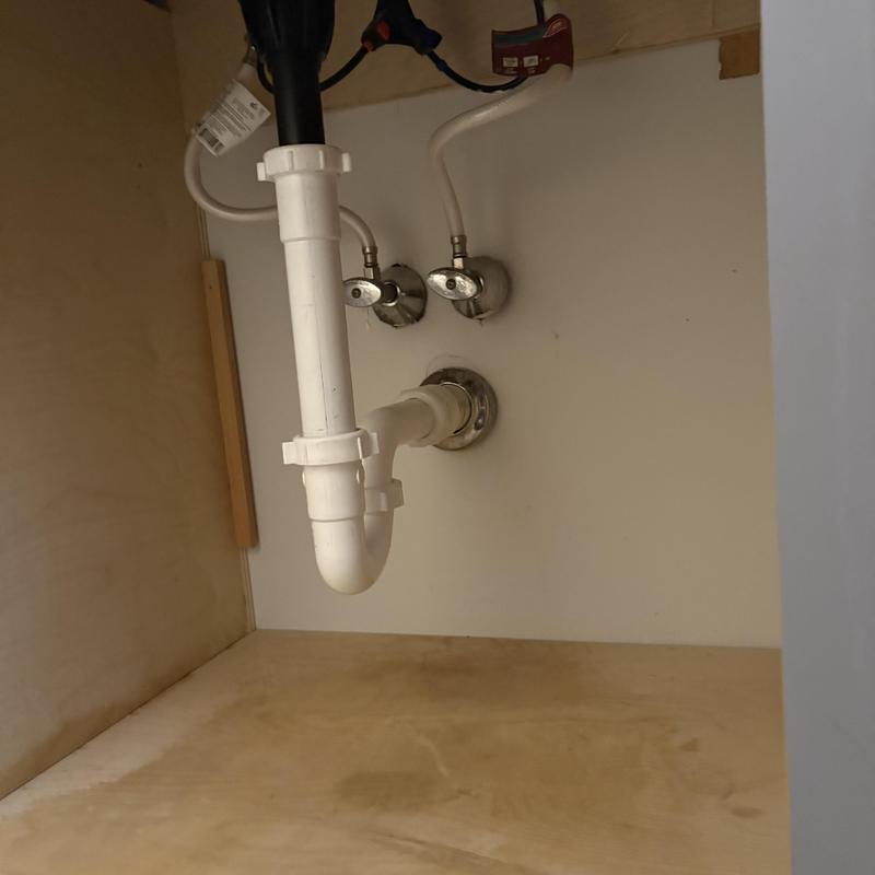 Bathroom sink drain trap and supply valves under cabinet Bathroom sink drain trap and supply valves under cabinet