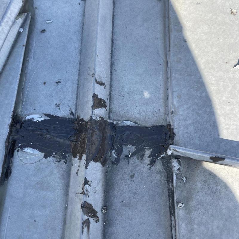Standing seam metal roof patched with sealant