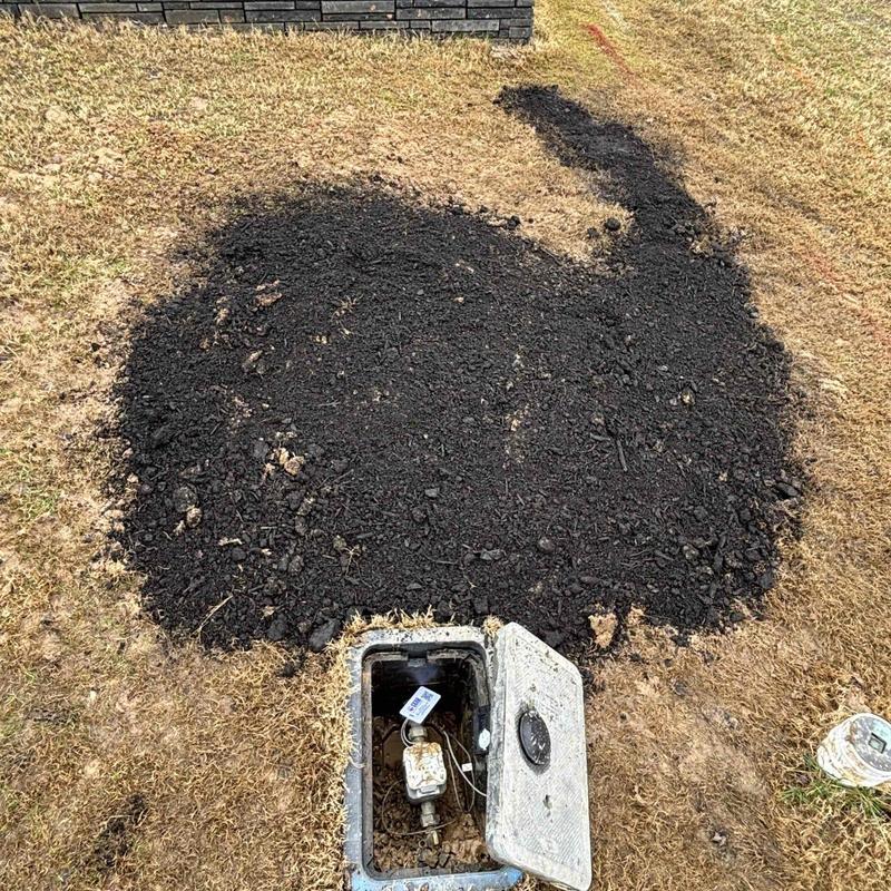 Water meter box with fresh soil backfill on lawn Water meter box with fresh soil backfill on lawn