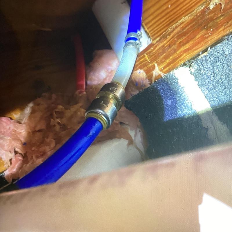 Water pipe with new connector in attic insulation