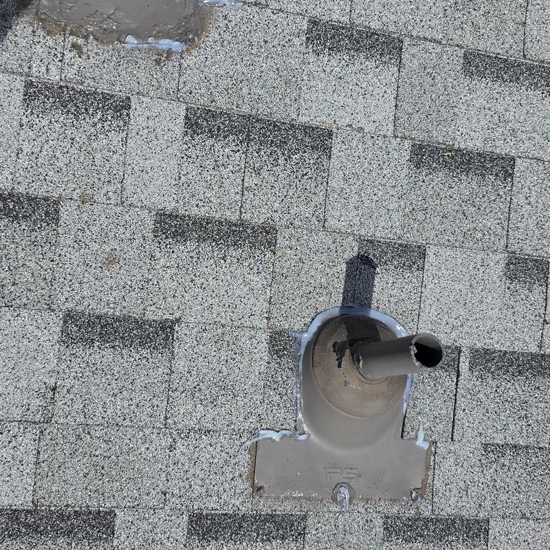 Roof vent pipe flashing with hail damage on shingles