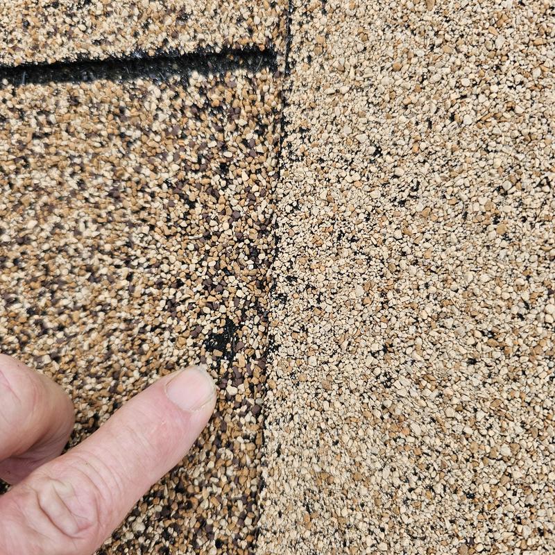 Asphalt shingle granule loss from hail damage close-up
