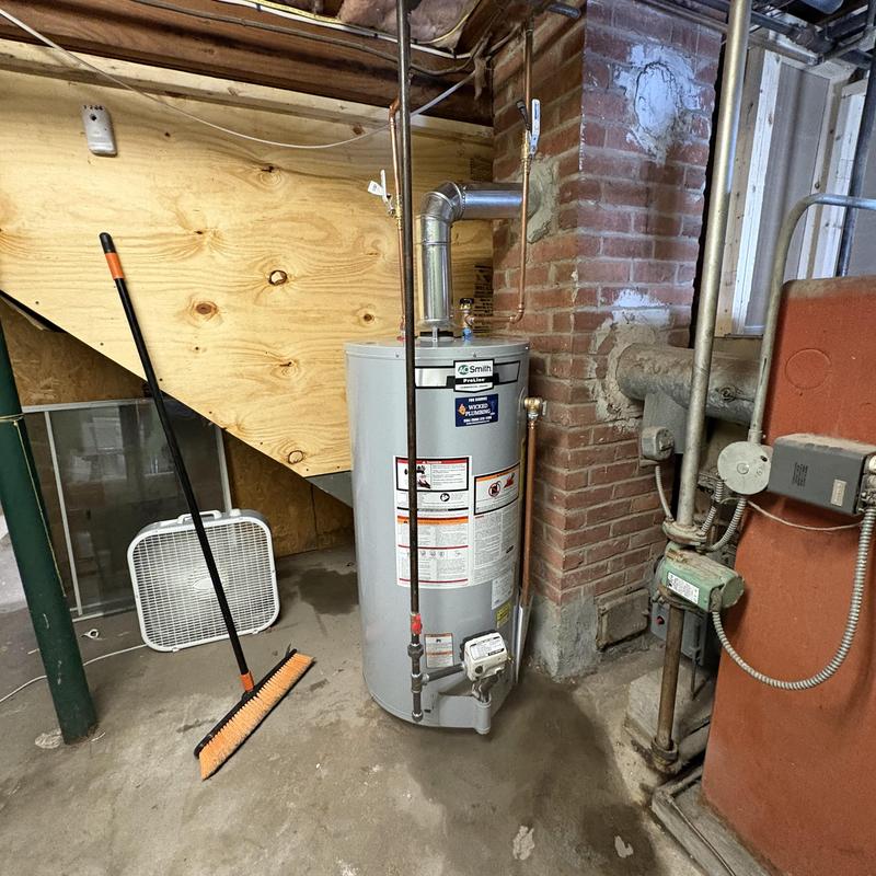 40 gallon water heater installed in basement corner