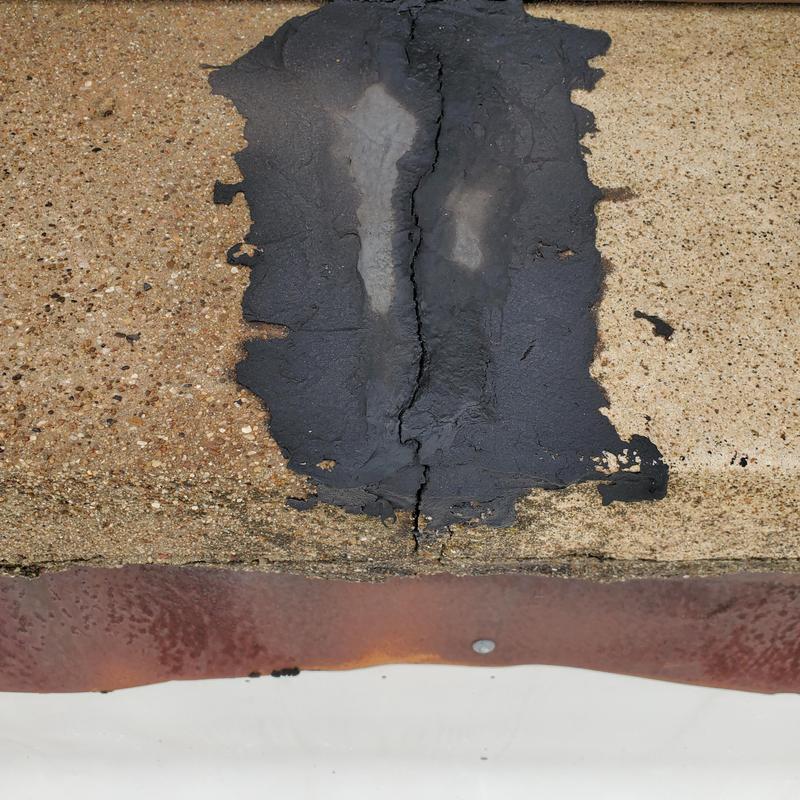 Roof crack with patch and weathered concrete surface